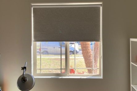 Home office window in Sunnyvale with blackout roller shade partially open, letting in natural light while still providing privacy.